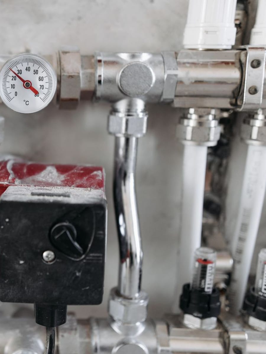 Manómetro, válvulas de latón y tubos de una instalación de agua vistos de cerca